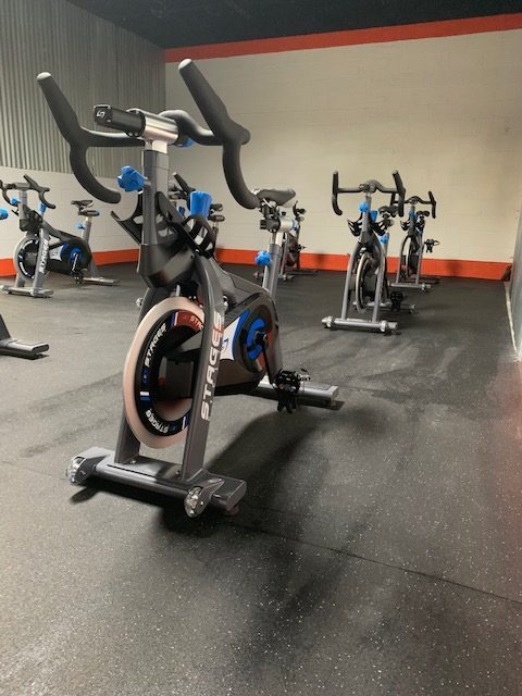 A group of exercise bikes in a gym.