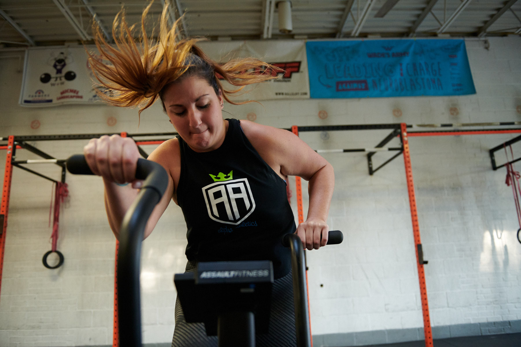 A woman is riding an exercise bike in the gym.
