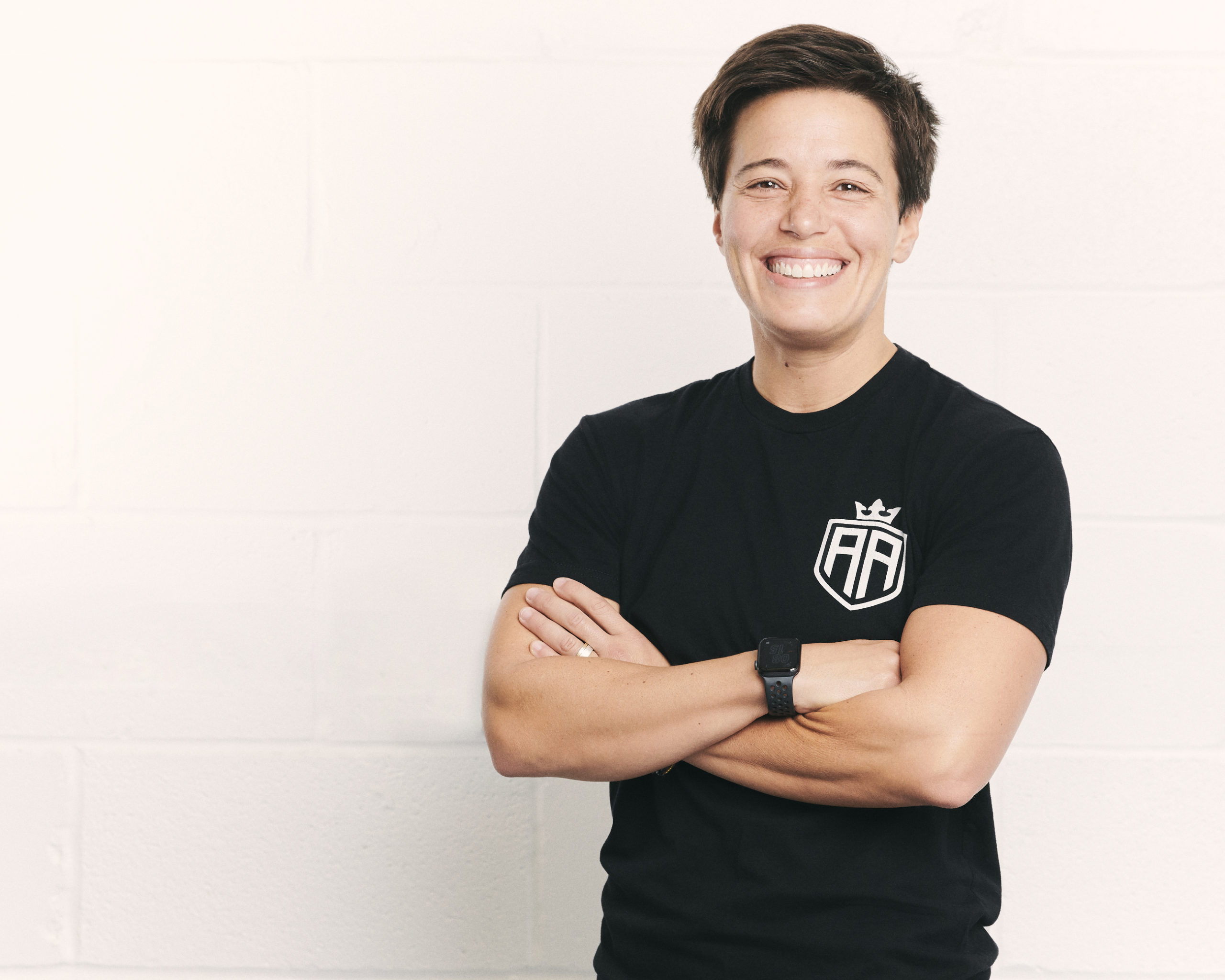 A man standing in front of a white wall.