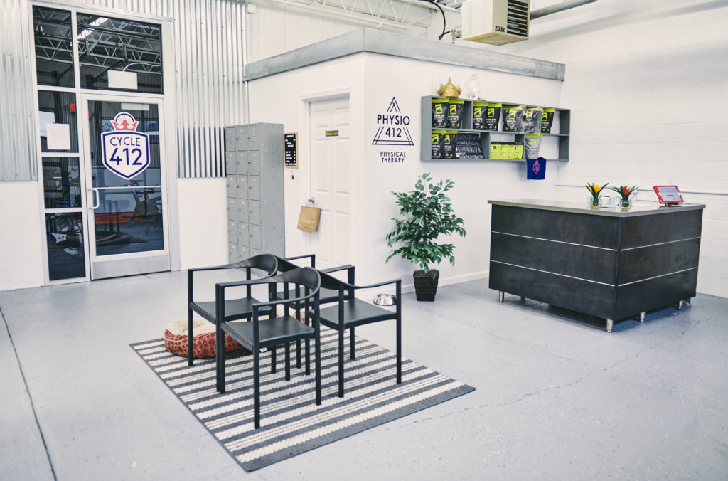 A room with black chairs and white walls.